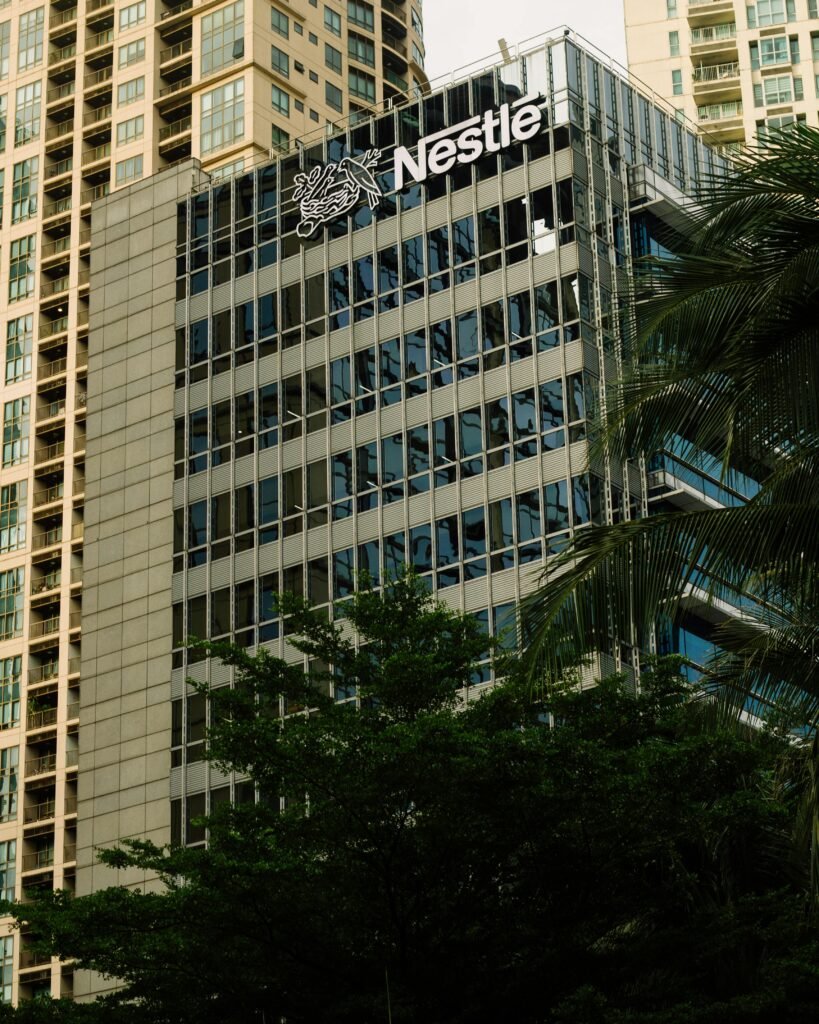 Nestle headquarters amidst modern urban architecture, showcasing sleek glass design.