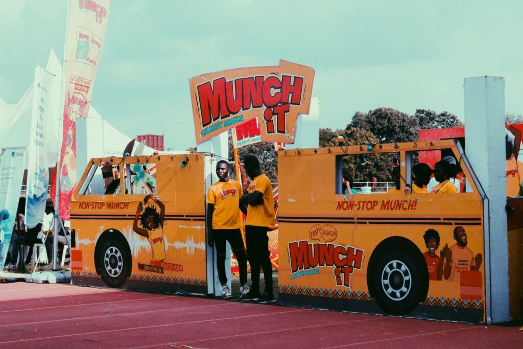 Colorful outdoor festival with Munch It branded stall and attendees in vibrant attire.